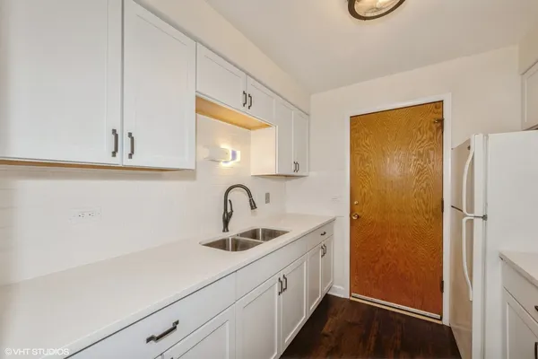 a kitchen with a sink and a refrigerator