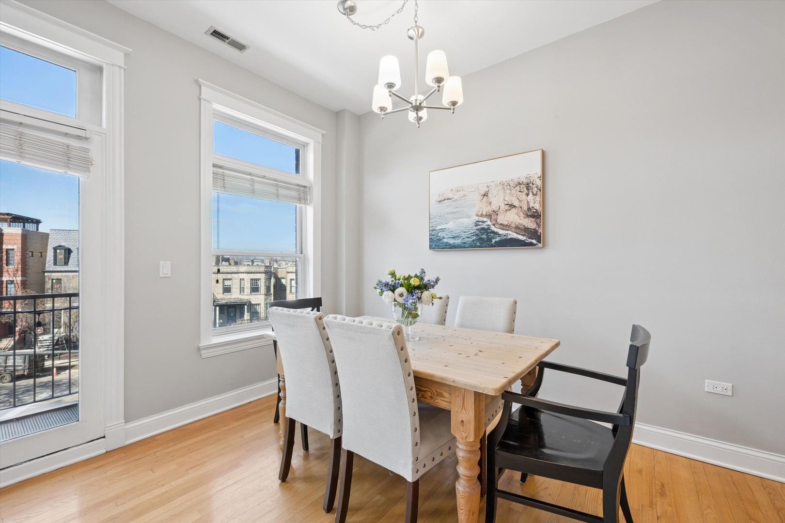 3755 North Racine Avenue, Unit 3C Chicago, IL 60613 - Photo 14 of 36 a view of a dining room with furniture and wooden floor