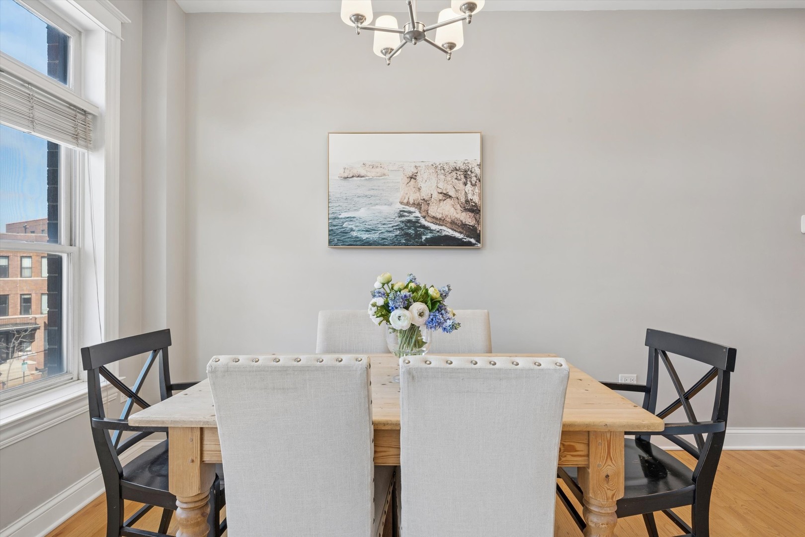 3755 North Racine Avenue, Unit 3C Chicago, IL 60613 - Photo 15 of 36 a view of a dining room with furniture and a chandelier