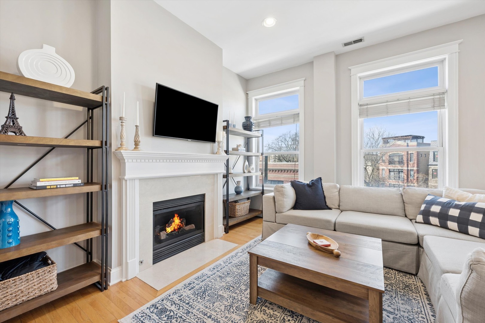 3755 North Racine Avenue, Unit 3C Chicago, IL 60613 - Photo 2 of 36 a living room with furniture a flat screen tv and a fireplace