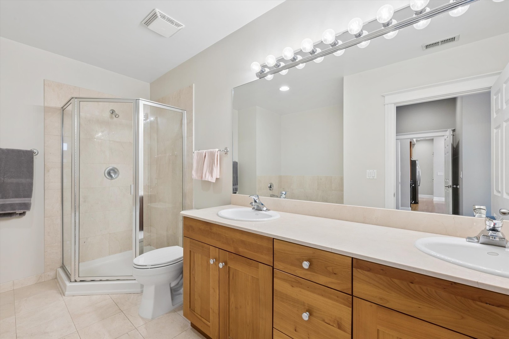 3755 North Racine Avenue, Unit 3C Chicago, IL 60613 - Photo 21 of 36 a bathroom with a sink double vanity granite toilet and shower