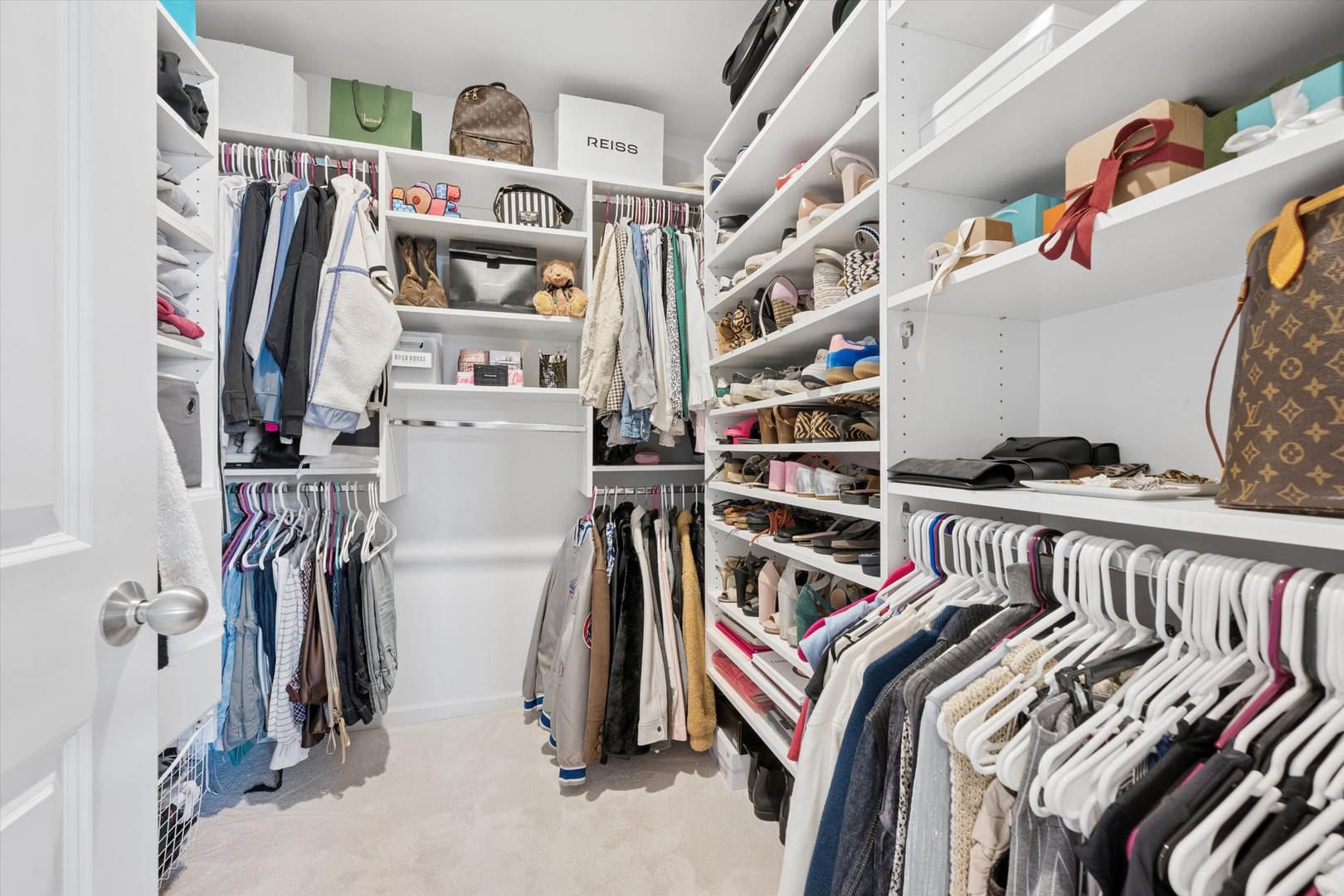 3755 North Racine Avenue, Unit 3C Chicago, IL 60613 - Photo 23 of 36 a view of walk in closet with clothes and shoes