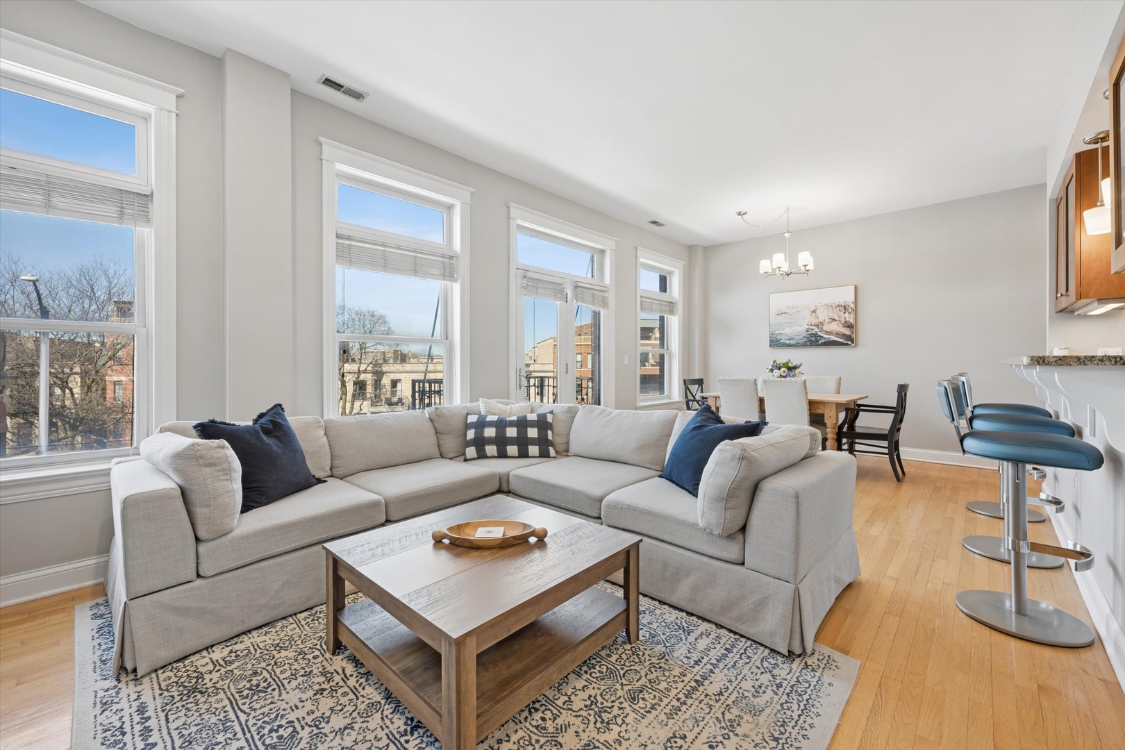 3755 North Racine Avenue, Unit 3C Chicago, IL 60613 - Photo 3 of 36 a living room with furniture a rug and a large window