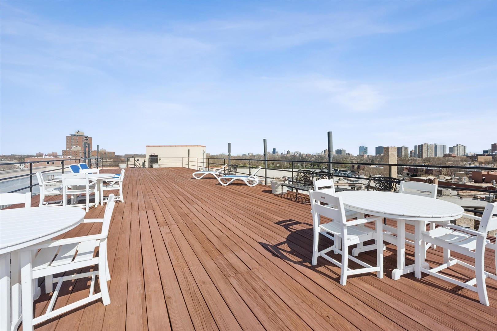 3755 North Racine Avenue, Unit 3C Chicago, IL 60613 - Photo 32 of 36 a view of a balcony with wooden floor