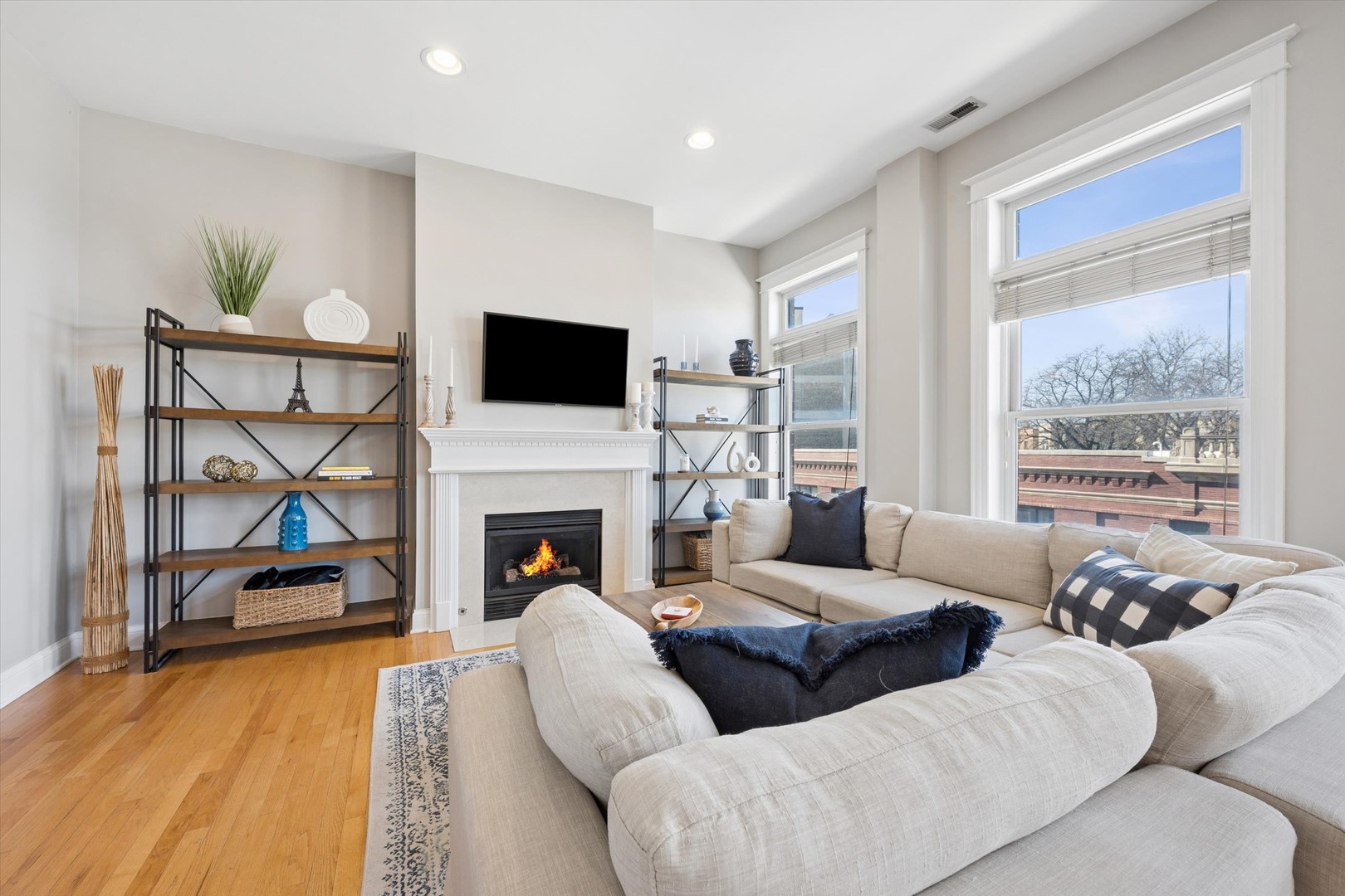3755 North Racine Avenue, Unit 3C Chicago, IL 60613 - Photo 4 of 36 a living room with furniture a fireplace and a flat screen tv