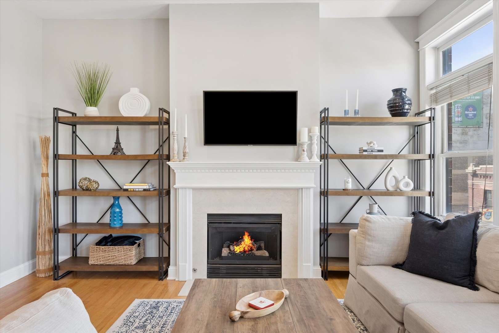 3755 North Racine Avenue, Unit 3C Chicago, IL 60613 - Photo 5 of 36 a living room with furniture a flat screen tv and a fireplace