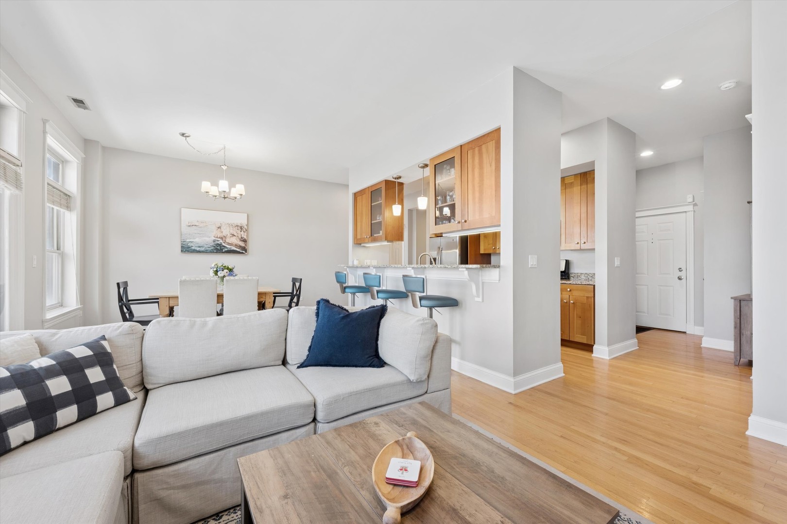 3755 North Racine Avenue, Unit 3C Chicago, IL 60613 - Photo 6 of 36 a living room with furniture and a wooden floor