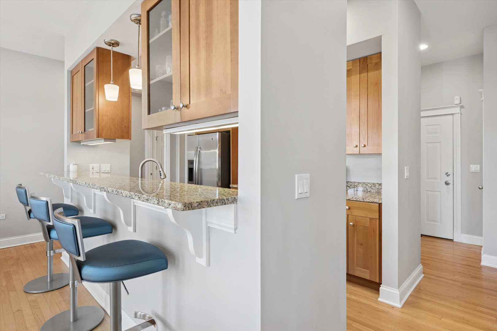 3755 North Racine Avenue, Unit 3C Chicago, IL 60613 - Photo 7 of 36 a kitchen with stainless steel appliances kitchen island granite countertop a refrigerator and a stove top oven