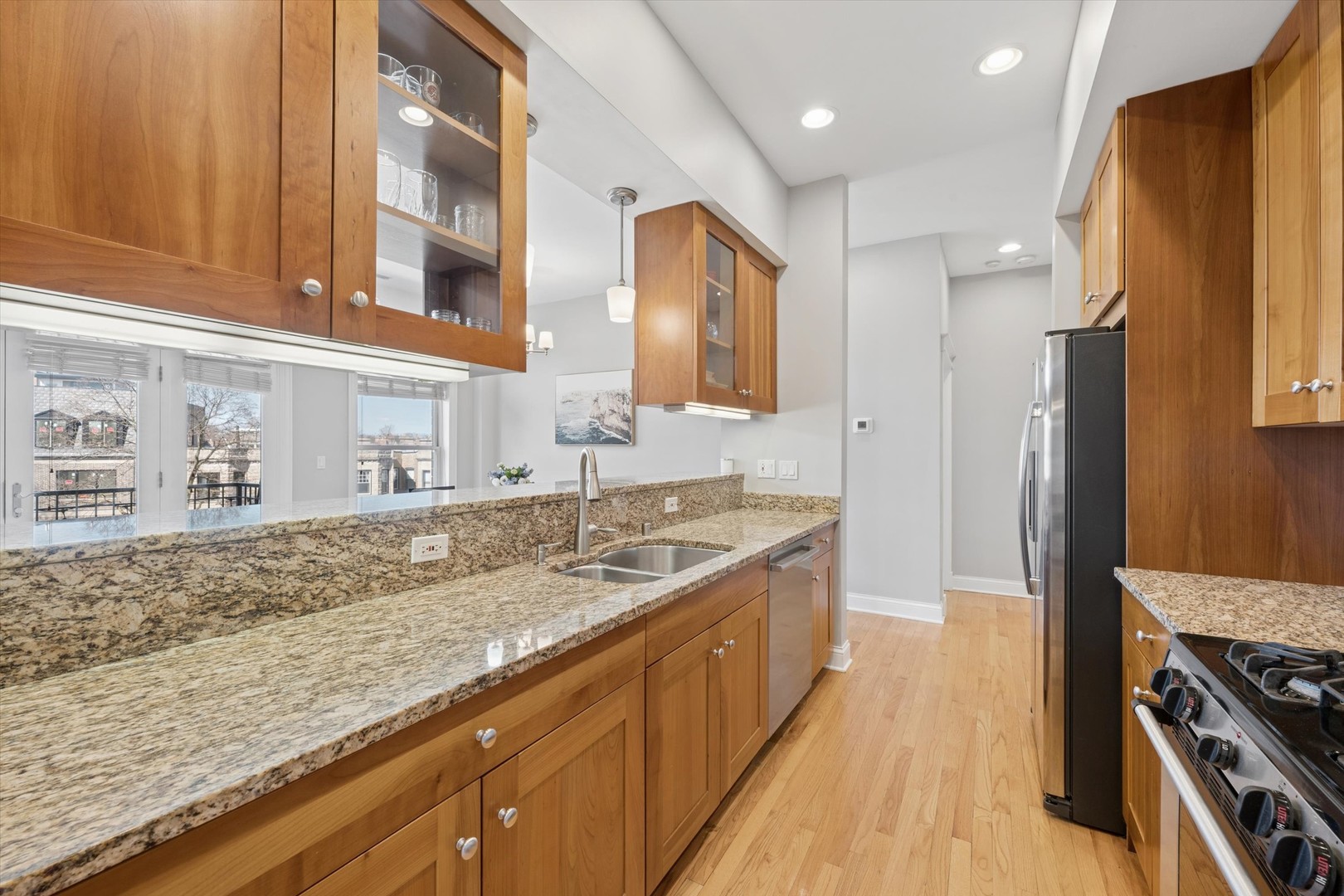 3755 North Racine Avenue, Unit 3C Chicago, IL 60613 - Photo 9 of 36 a kitchen with stainless steel appliances granite countertop a sink stove and refrigerator