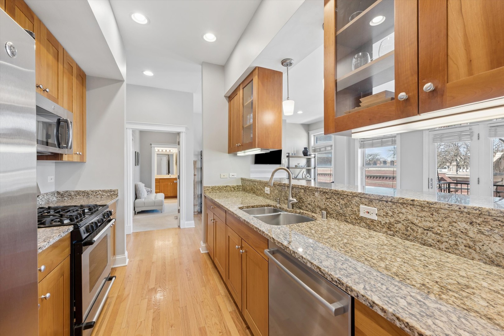 3755 North Racine Avenue, Unit 3C Chicago, IL 60613 - Photo 10 of 36 a kitchen with stainless steel appliances granite countertop a sink stove and refrigerator