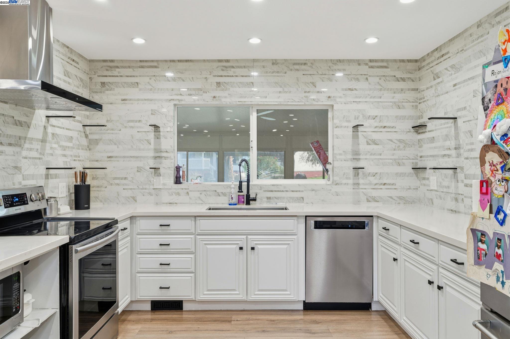 34724 Bernard Road Tracy, CA 95377 - Photo 14 of 60 a kitchen with granite countertop a sink stainless steel appliances and cabinets