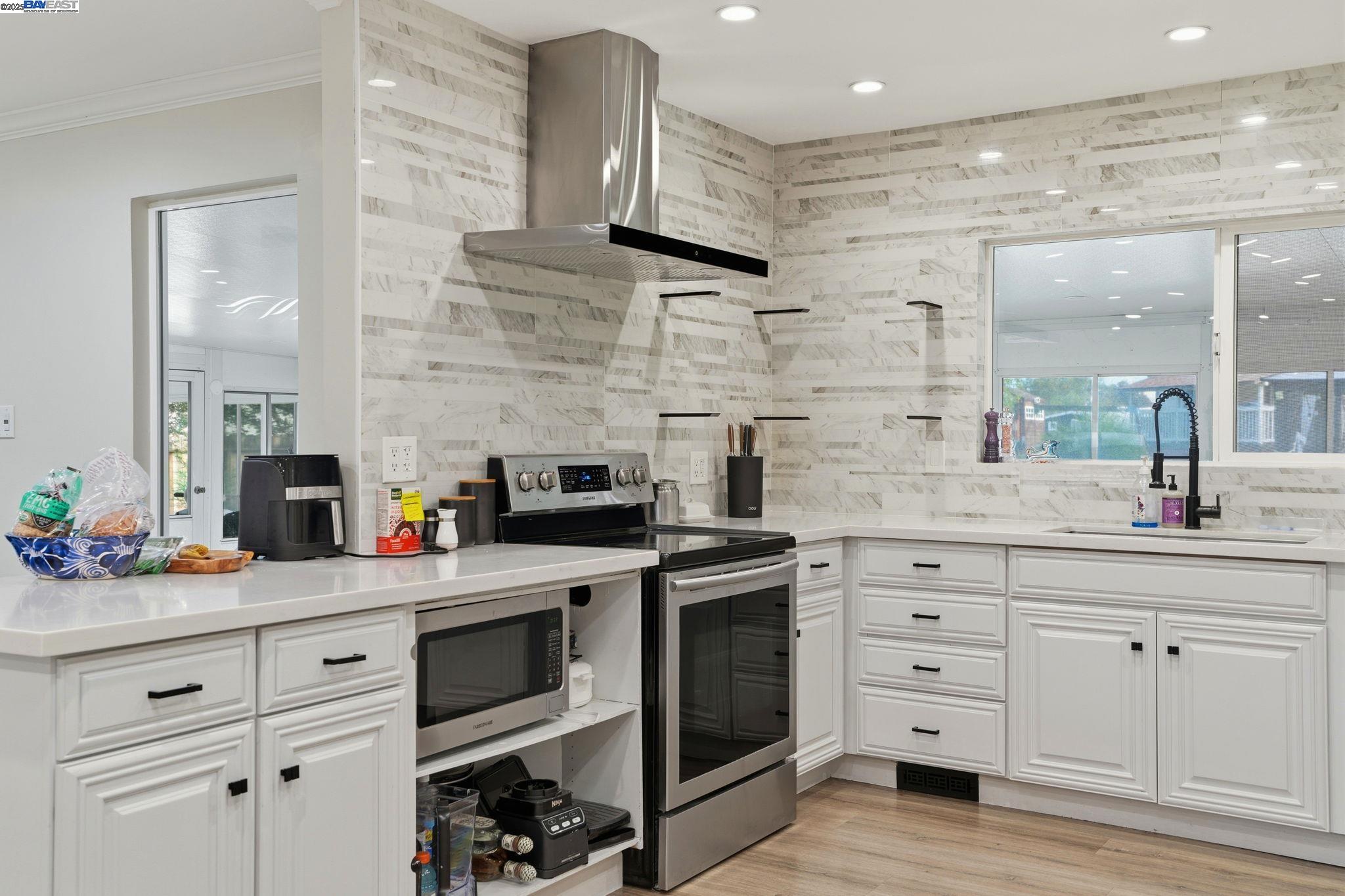 34724 Bernard Road Tracy, CA 95377 - Photo 15 of 60 a kitchen with stainless steel appliances white cabinets and a stove