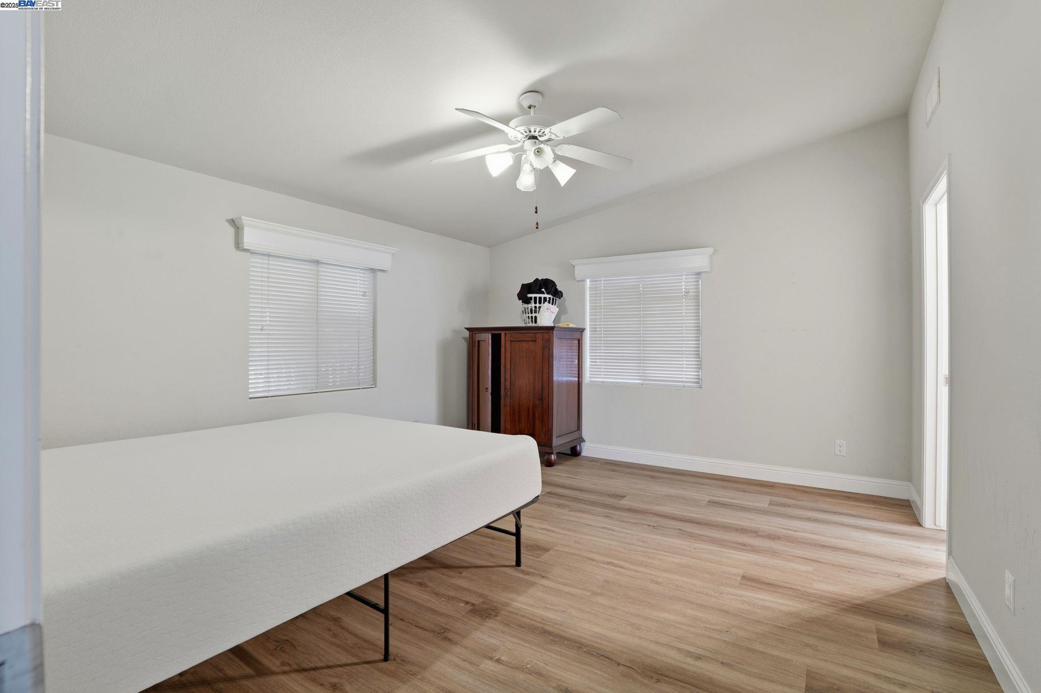 34724 Bernard Road Tracy, CA 95377 - Photo 33 of 60 a room with a bed and a chandelier