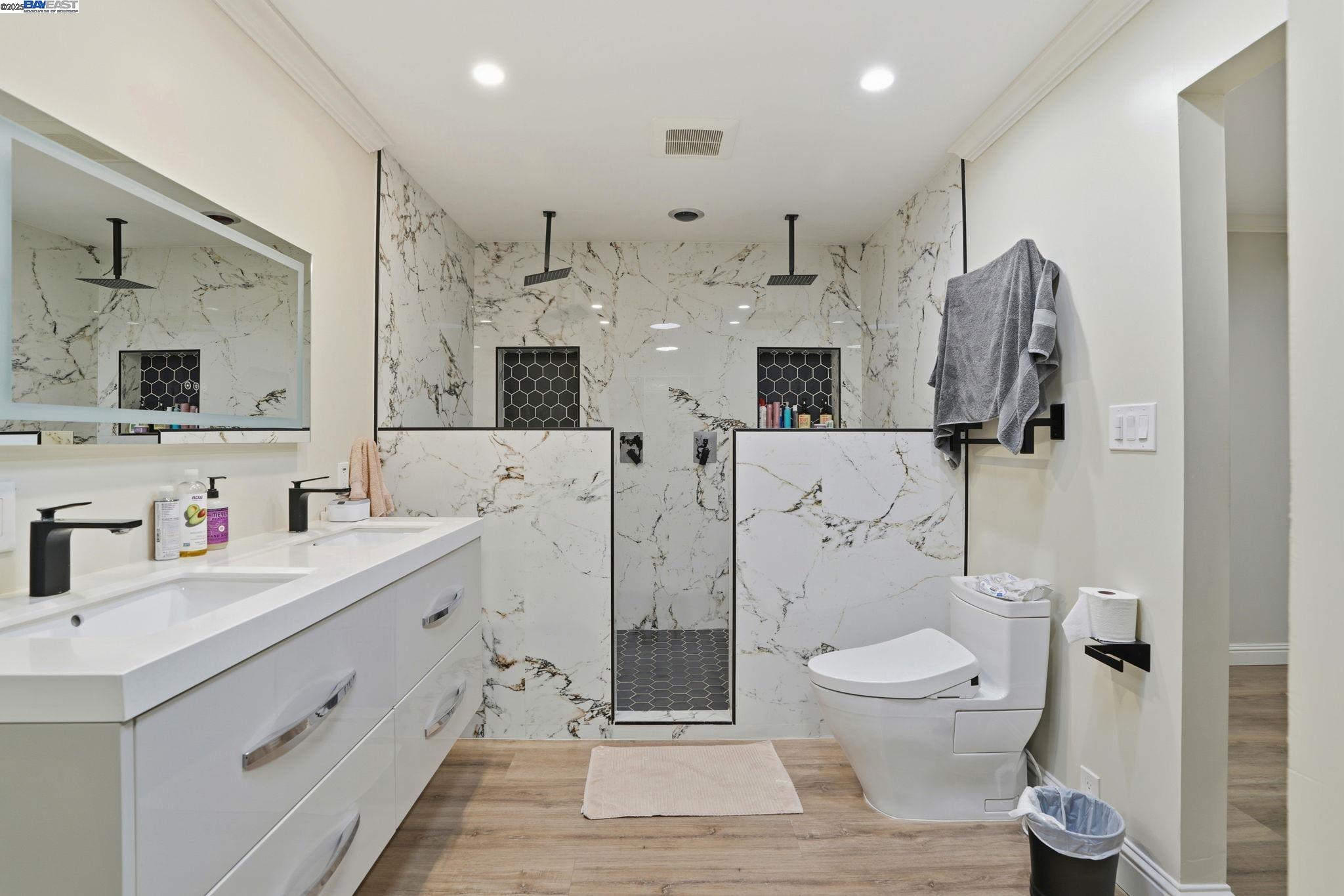 34724 Bernard Road Tracy, CA 95377 - Photo 39 of 60 a bathroom with a toilet sink double vanity and mirror