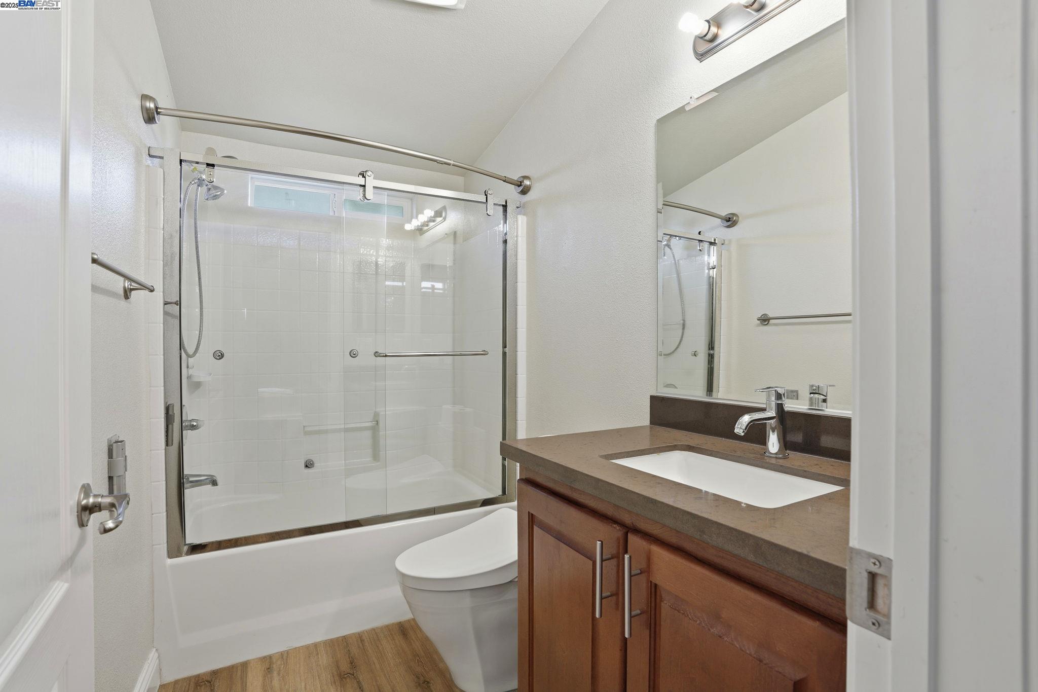 34724 Bernard Road Tracy, CA 95377 - Photo 43 of 60 a bathroom with a granite countertop sink toilet and shower