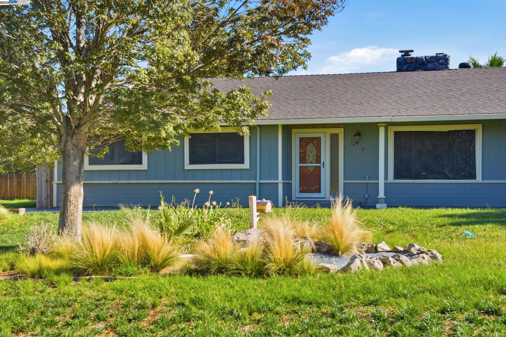 34724 Bernard Road Tracy, CA 95377 - Photo 5 of 60 front view of a house with a yard