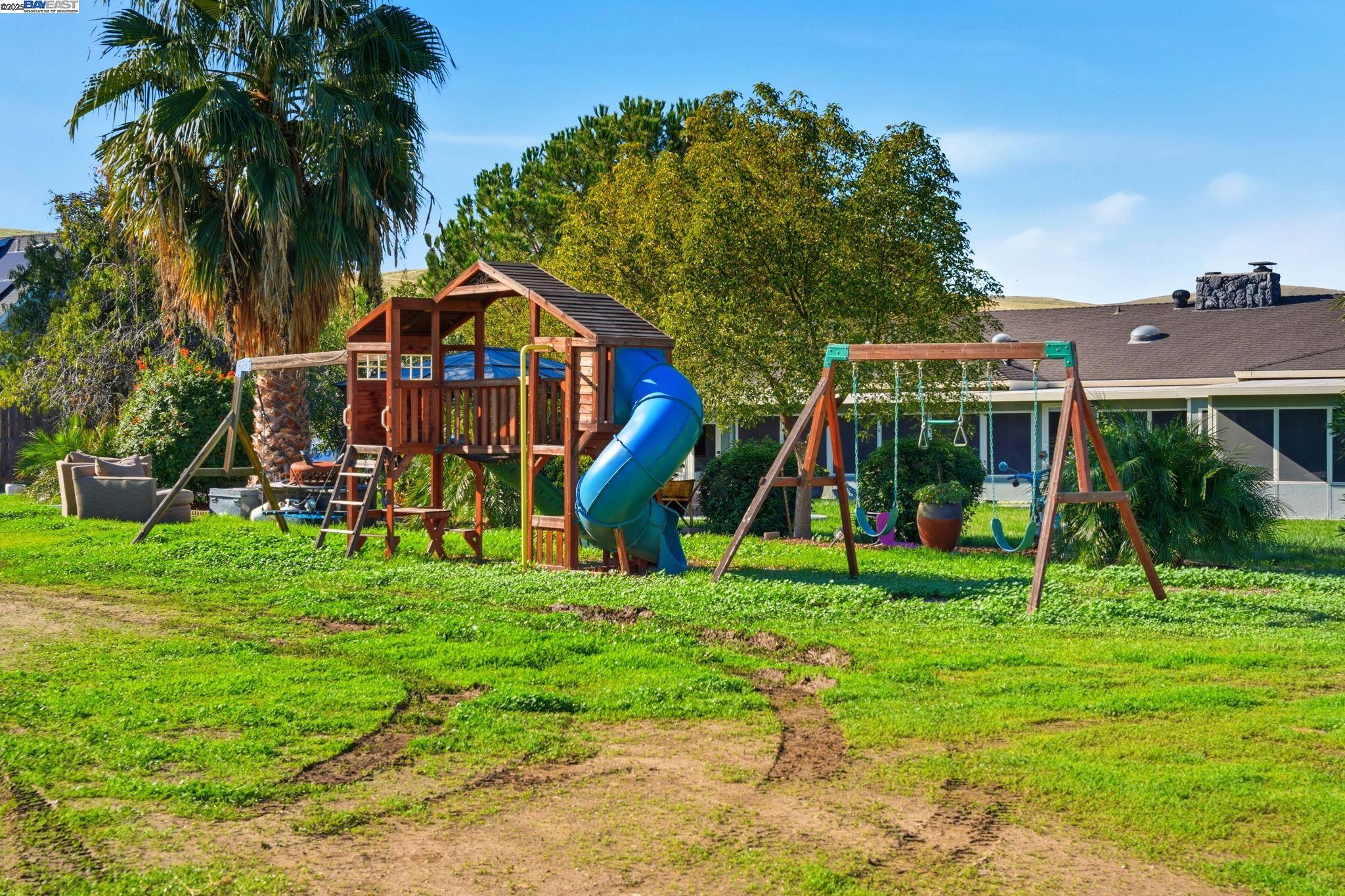 34724 Bernard Road Tracy, CA 95377 - Photo 59 of 60 a view of a house with a backyard and a tree