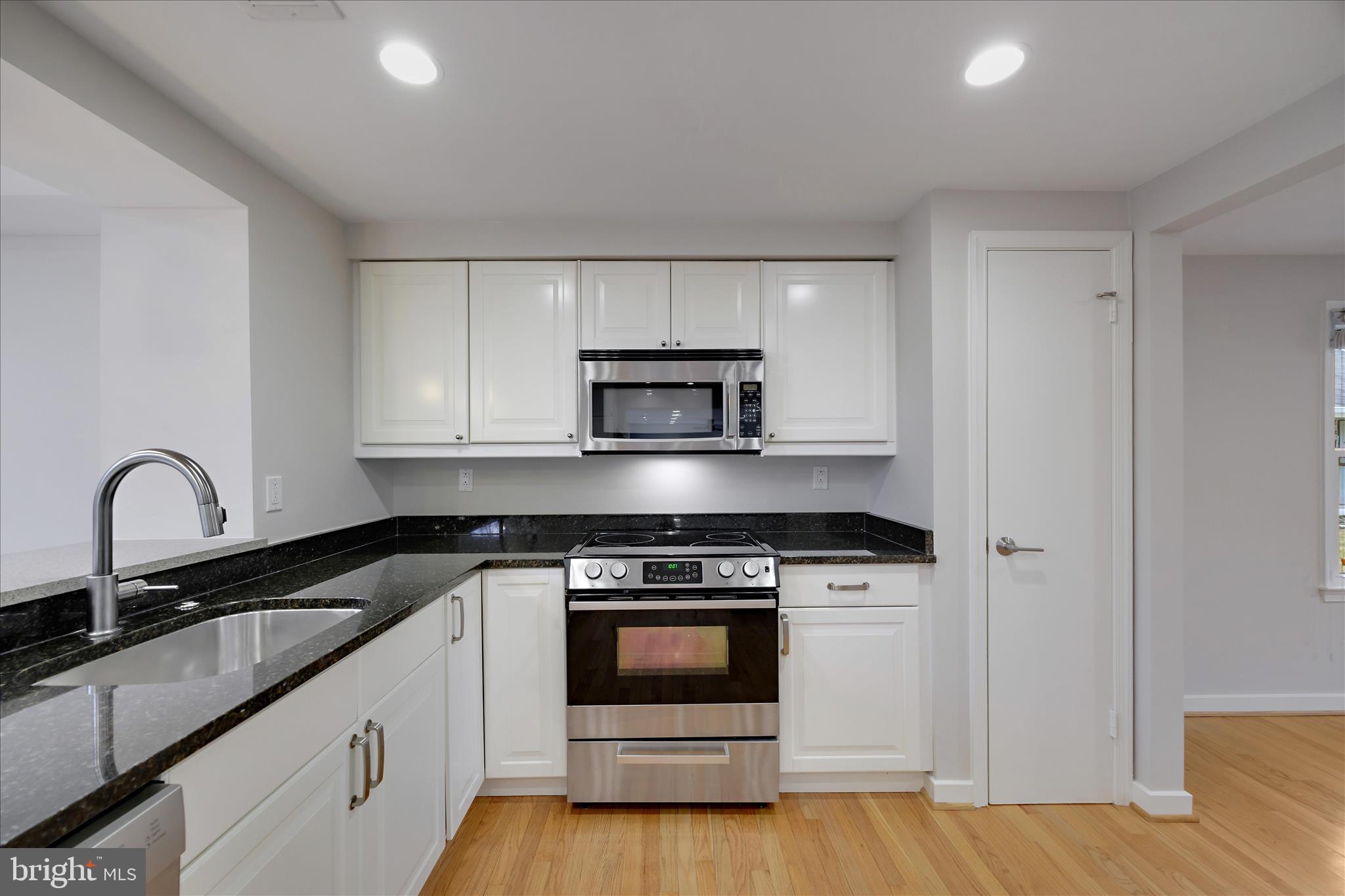 6278 Branch Beech Columbia, MD 21044 - Photo 13 of 57 a kitchen with granite countertop a stove and a sink