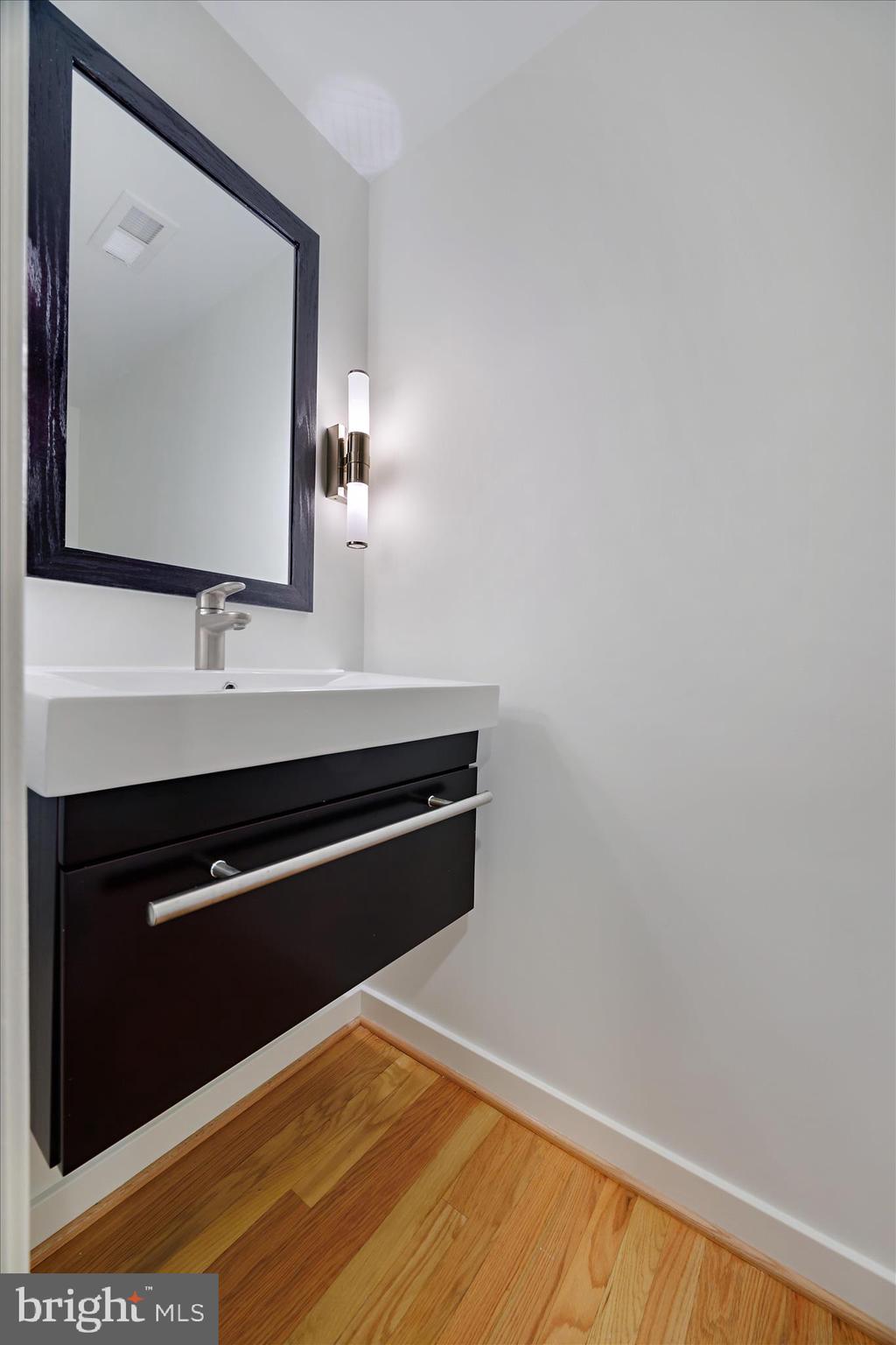 6278 Branch Beech Columbia, MD 21044 - Photo 19 of 57 a bathroom with a sink and a mirror