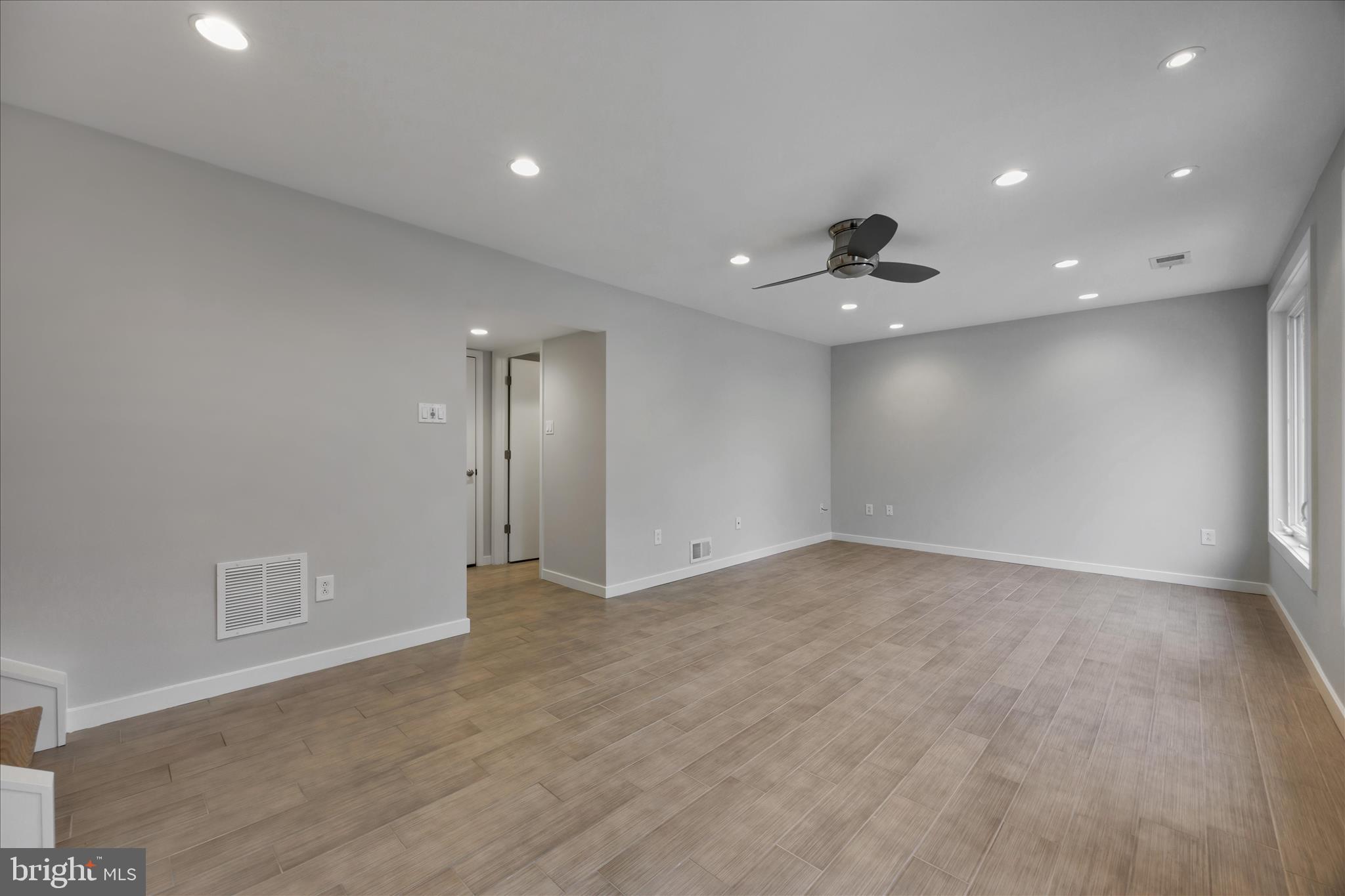 6278 Branch Beech Columbia, MD 21044 - Photo 24 of 57 wooden floor in an empty room with a ceiling fan