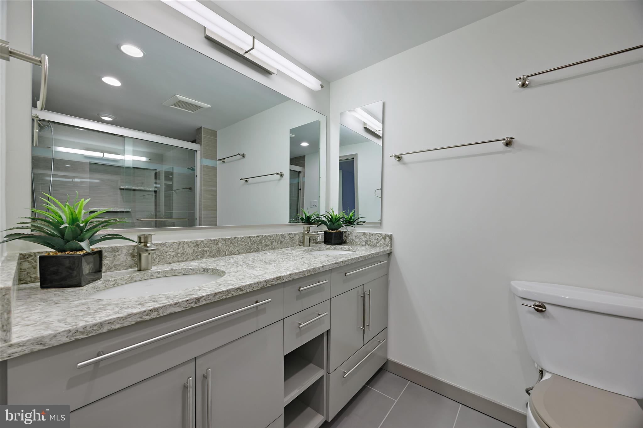 6278 Branch Beech Columbia, MD 21044 - Photo 31 of 57 a bathroom with a granite countertop sink a toilet and a mirror