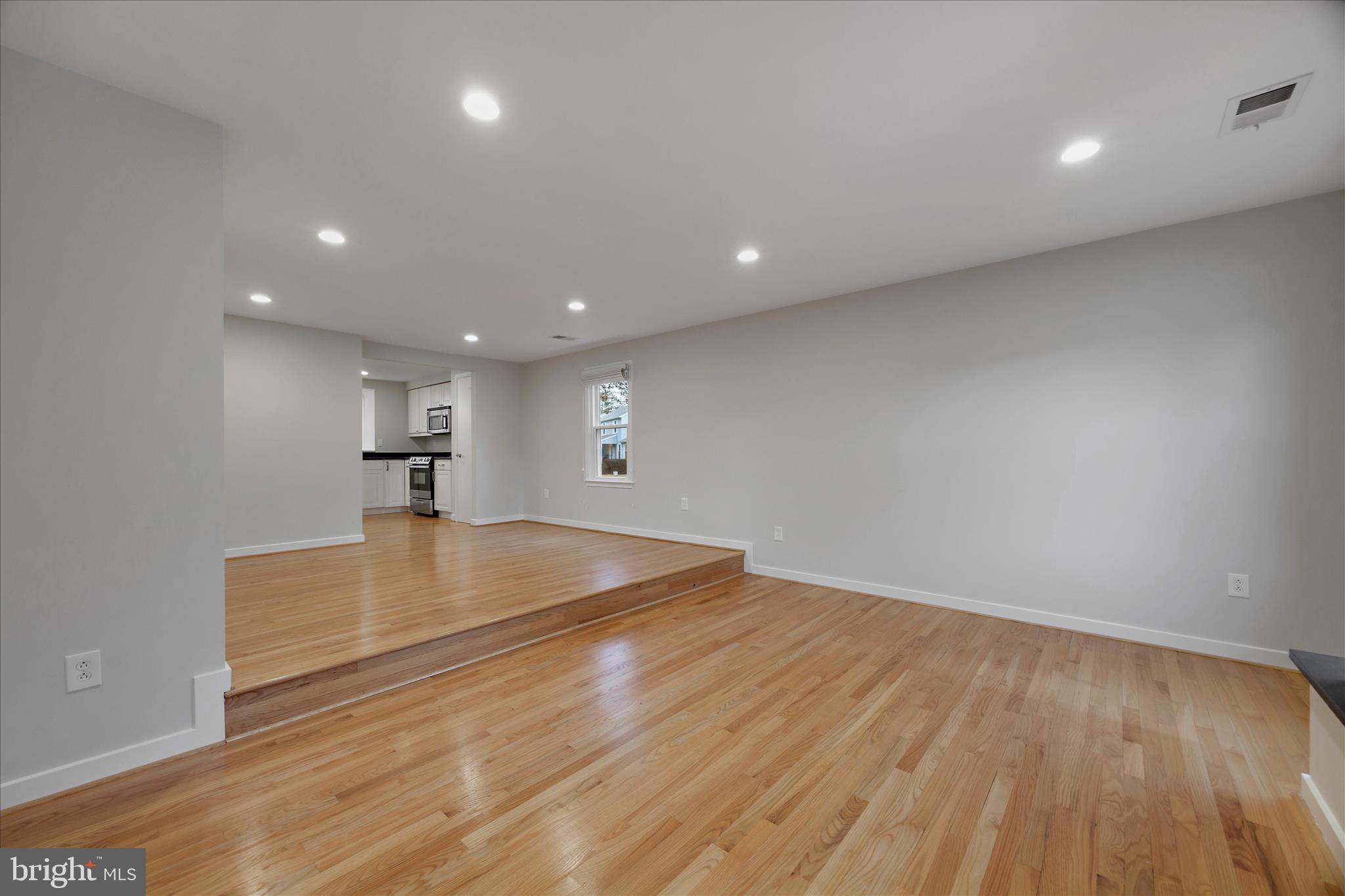 6278 Branch Beech Columbia, MD 21044 - Photo 6 of 57 a view of kitchen and empty room with wooden floor