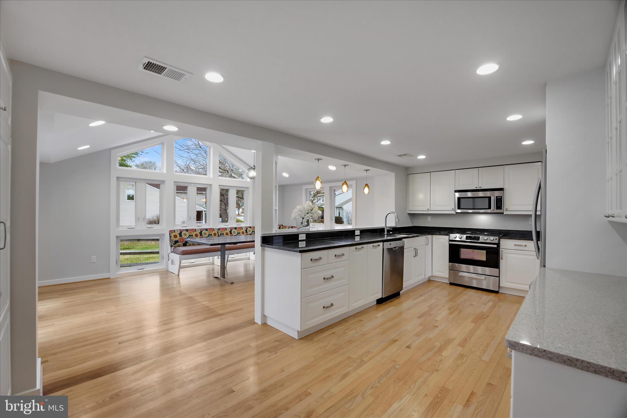 6278 Branch Beech Columbia, MD 21044 - Photo 10 of 57 a kitchen with stainless steel appliances kitchen island granite countertop a stove a sink and a refrigerator