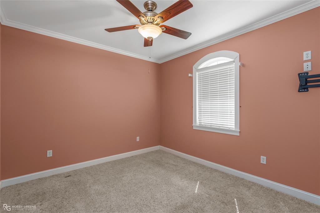 703 Airport Loop Homer, LA 71040 - Photo 18 of 32 an empty room with a window and a fan