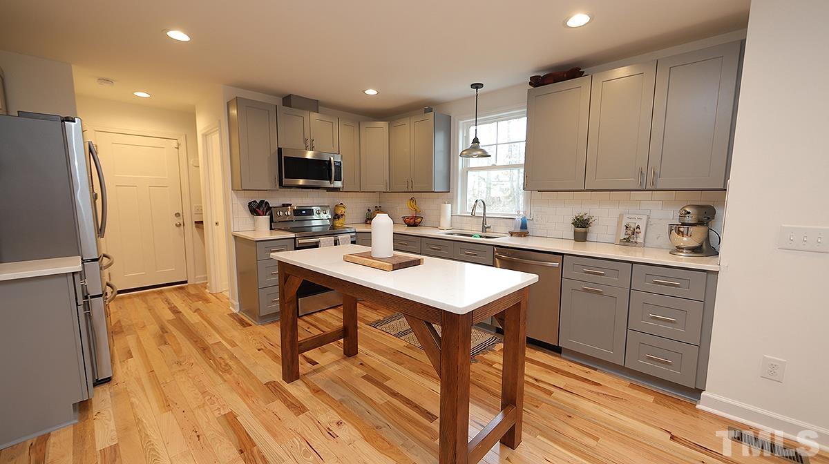 5000 West Pool Road Rougemont, NC 27572 - Photo 12 of 29 a kitchen with a sink a refrigerator and cabinets