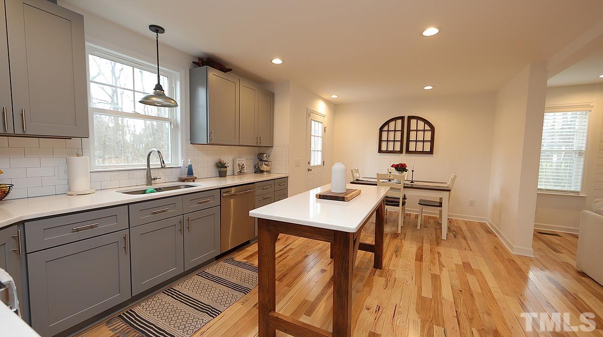 5000 West Pool Road Rougemont, NC 27572 - Photo 13 of 29 a kitchen with sink cabinets and dining table
