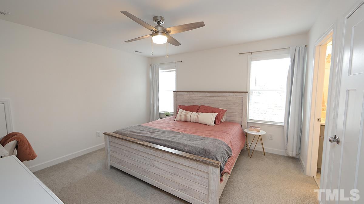 5000 West Pool Road Rougemont, NC 27572 - Photo 20 of 29 a bedroom with a bed and a chandelier