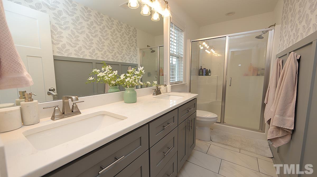 5000 West Pool Road Rougemont, NC 27572 - Photo 22 of 29 a bathroom with a double vanity sink mirror and shower