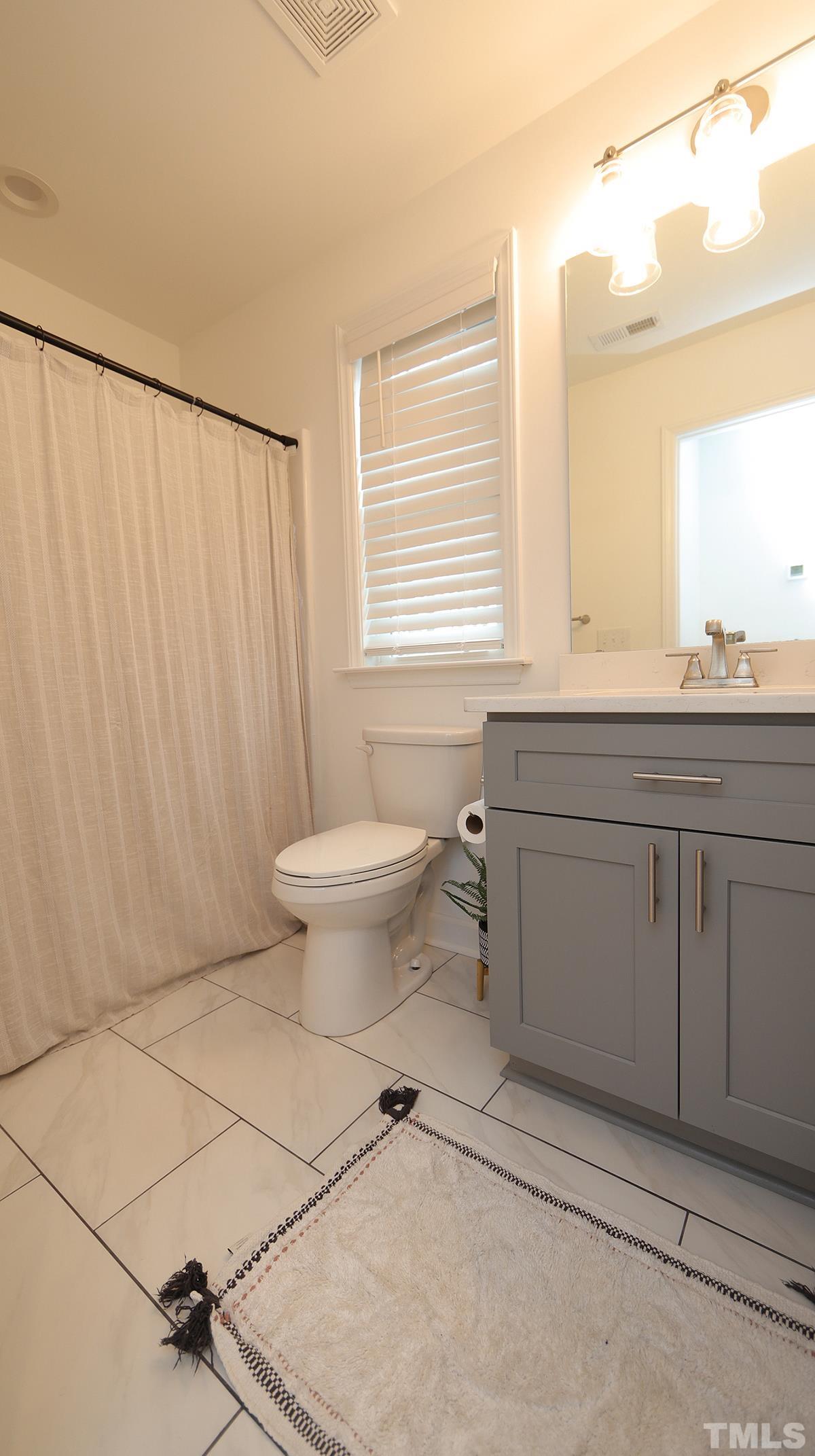 5000 West Pool Road Rougemont, NC 27572 - Photo 26 of 29 a bathroom with a sink toilet and vanity