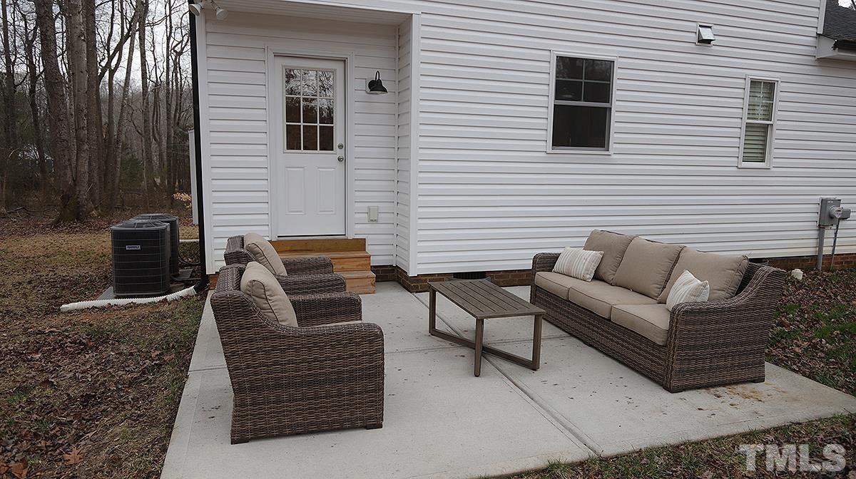 5000 West Pool Road Rougemont, NC 27572 - Photo 27 of 29 a view of a patio with couches chairs and a stove