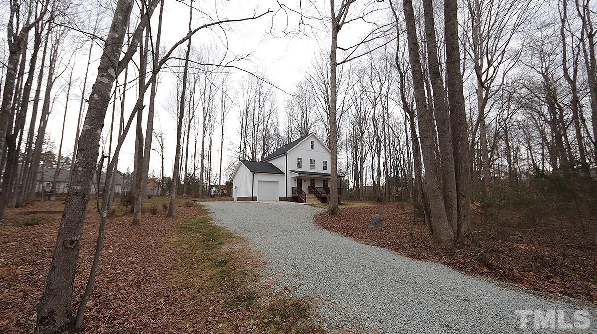 5000 West Pool Road Rougemont, NC 27572 - Photo 3 of 29 a view of a house with a large tree and wooden fence