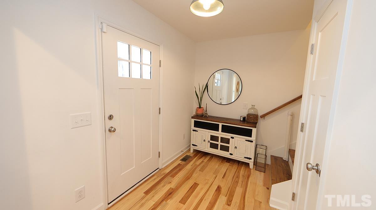 5000 West Pool Road Rougemont, NC 27572 - Photo 5 of 29 a view of a hallway with entryway wooden floor and front door