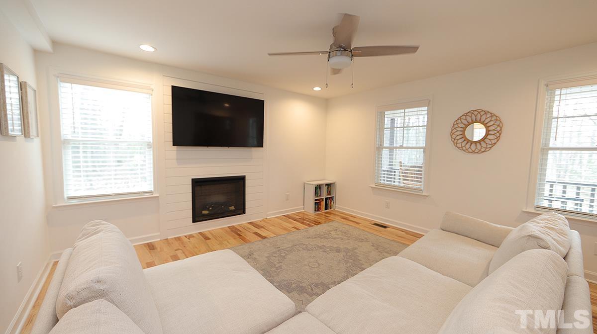 5000 West Pool Road Rougemont, NC 27572 - Photo 8 of 29 a living room with furniture a fireplace and a flat screen tv