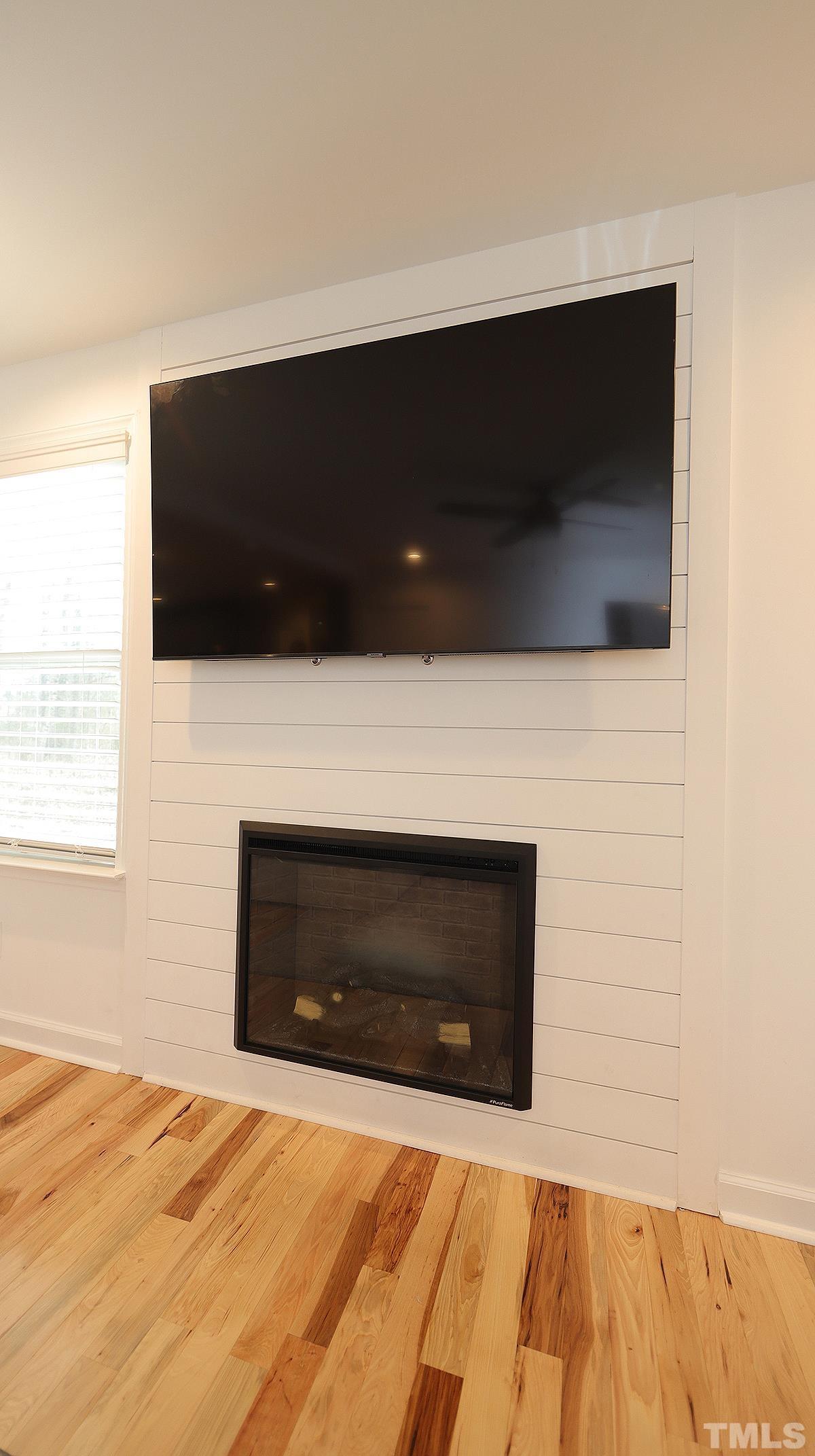 5000 West Pool Road Rougemont, NC 27572 - Photo 9 of 29 a living room with a flat screen tv and a fireplace