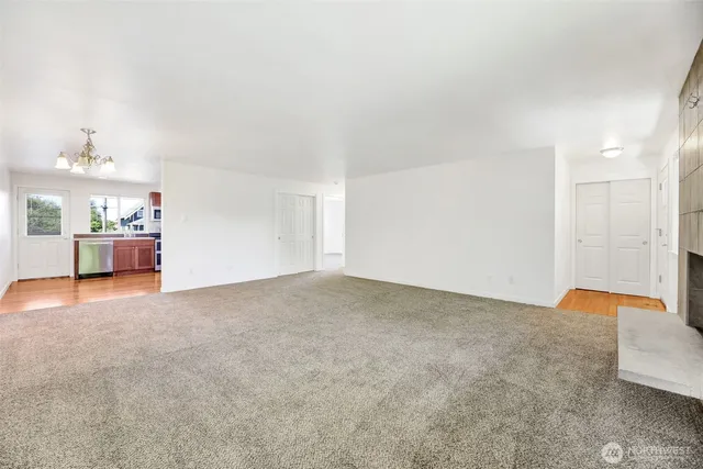 a kitchen with a refrigerator sink and wooden floor