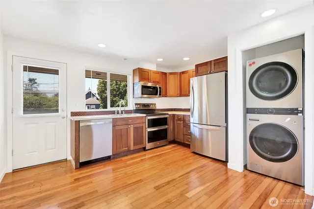 a view of kitchen with furniture and refrigerator