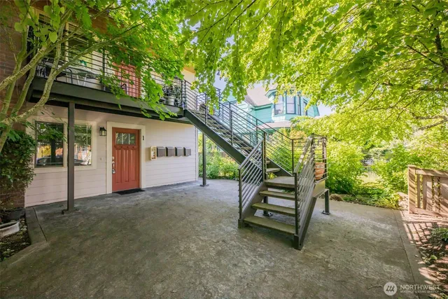 a backyard of a house with barbeque oven table and chairs