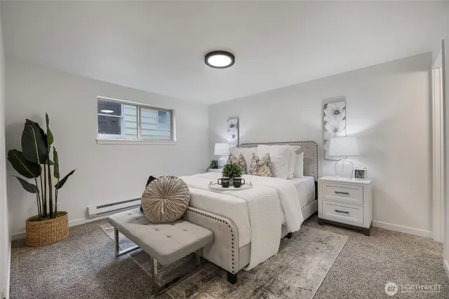 a bedroom with a bed and a potted plant