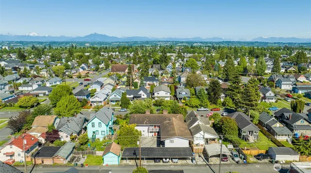 an aerial view of a houses with yard