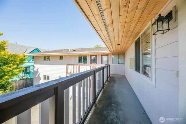 a view of a house with large windows and a small yard