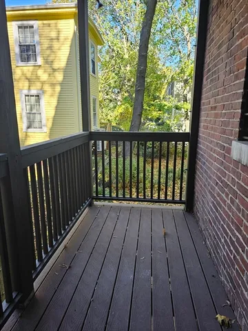 a view of wooden balcony with wooden floor