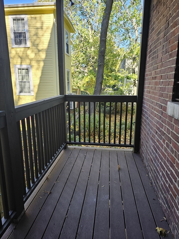361 Harvard Street, Unit 2 Cambridge, MA 02138 - Photo 5 of 8 a view of wooden balcony with wooden floor