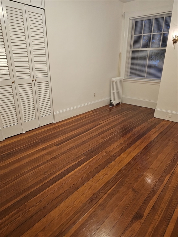 361 Harvard Street, Unit 2 Cambridge, MA 02138 - Photo 7 of 8 a view of empty room with wooden floor and fan
