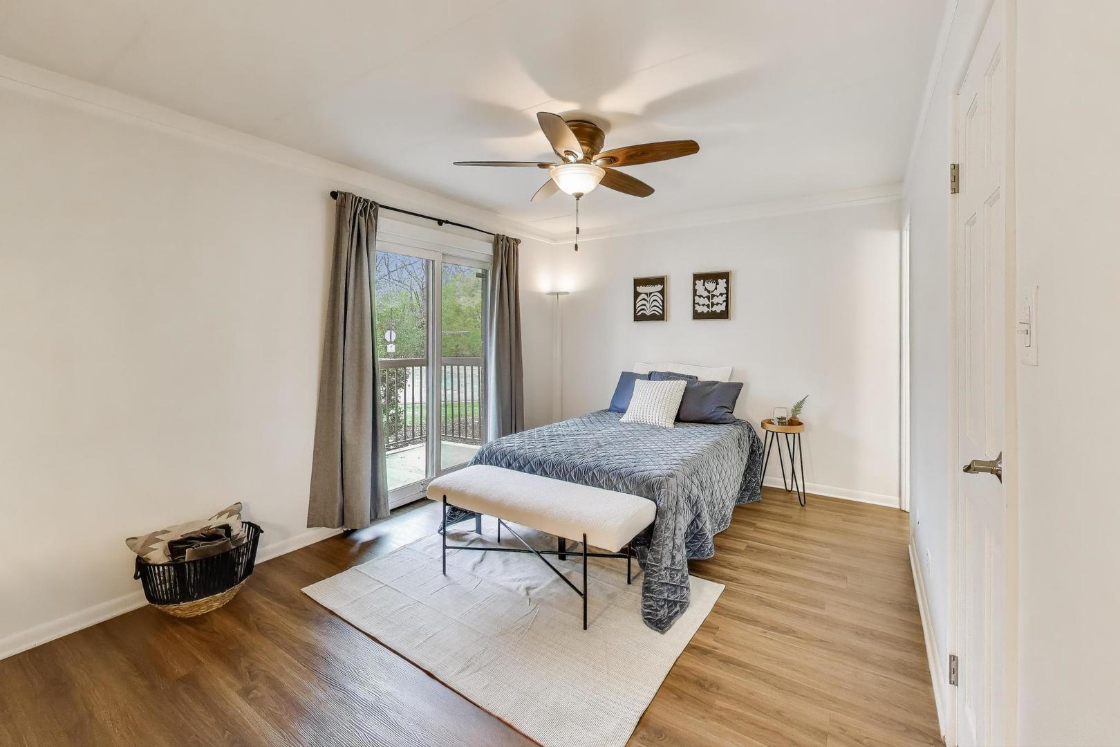 6443 Clarendon Hills Road, Unit 100D Willowbrook, IL 60527 - Photo 15 of 31 a bedroom with a bed and wooden floor