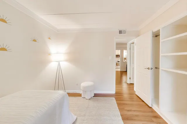 a bedroom with a bed and a lamp