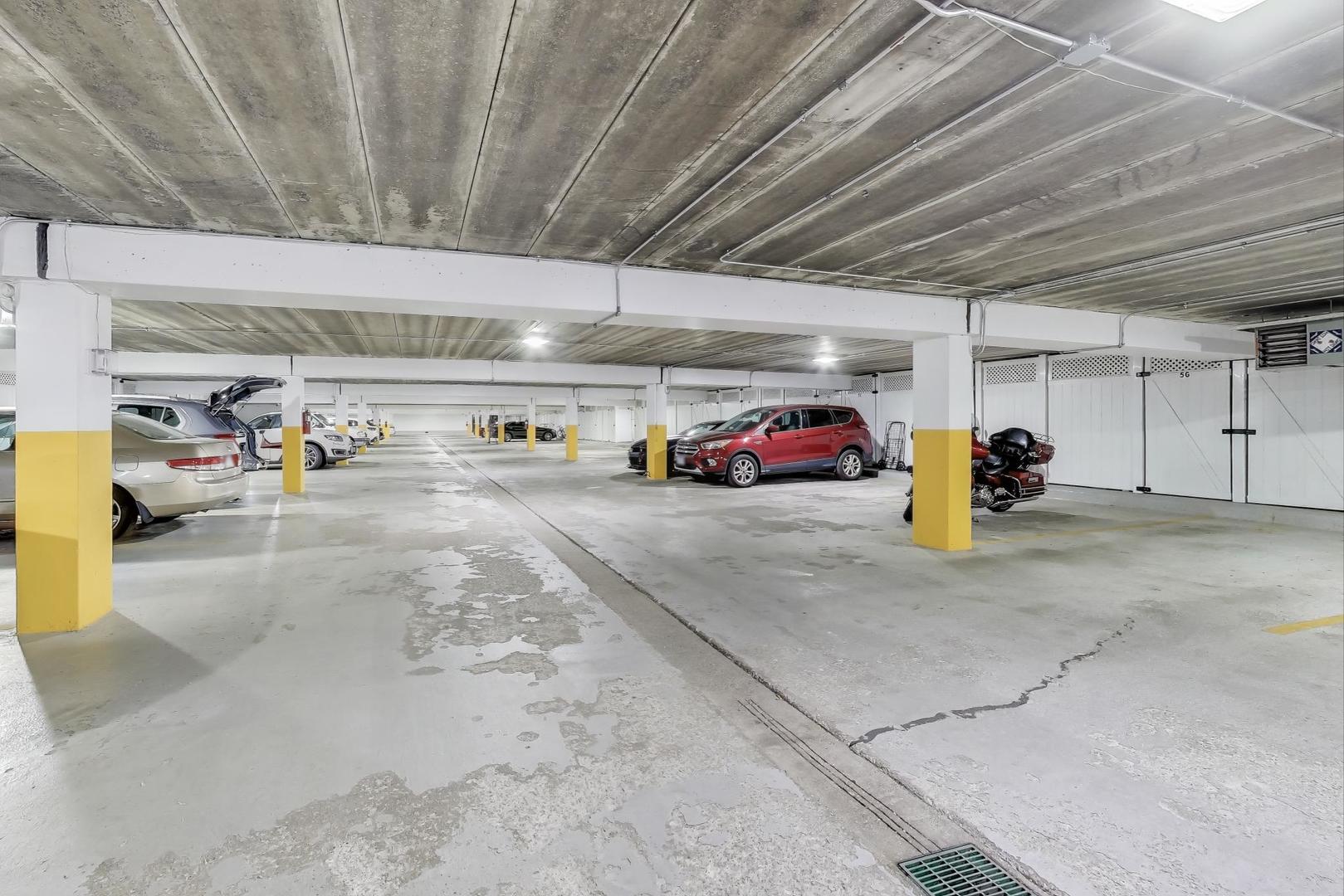 6443 Clarendon Hills Road, Unit 100D Willowbrook, IL 60527 - Photo 25 of 31 a view of parking garage with cars